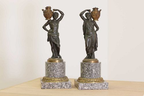 A pair of bronze figural candlesticks,