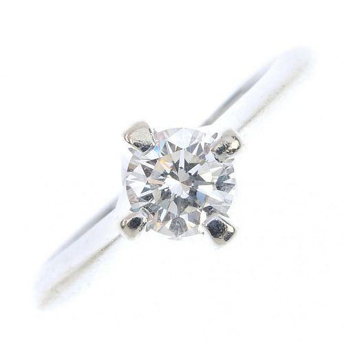 A diamond single-stone ring. The brilliant-cut diamond, to the tapered shoulders and plain band. Dia