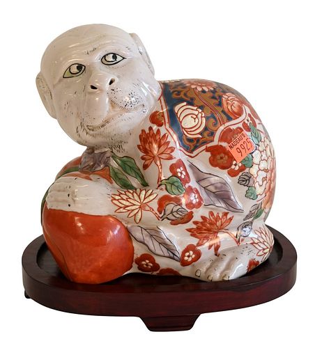Chinese Ceramic Painted Monkey Figure, set on wood stand, figure height 7 1/4 inches.