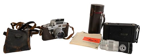 Leica M3 Camera, having Leica Elmar 1:4/135 mm and telescoping lens, some original Leica booklets along with Kodak box camera. Provenance: The Estate 