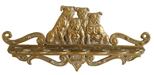 Brass Wall Mounted Pipe Holder, having four bulldogs over six pipe slots, length 12 1/2 inches.