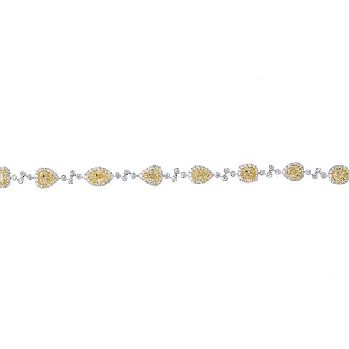 * A diamond and coloured diamond bracelet. Designed as a series of vari-shape 'yellow' diamonds, eac