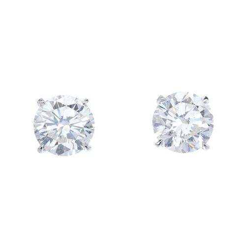 A pair of brilliant-cut diamond ear studs, weighing 3.01cts and 3.02cts. Accompanied by report numbe