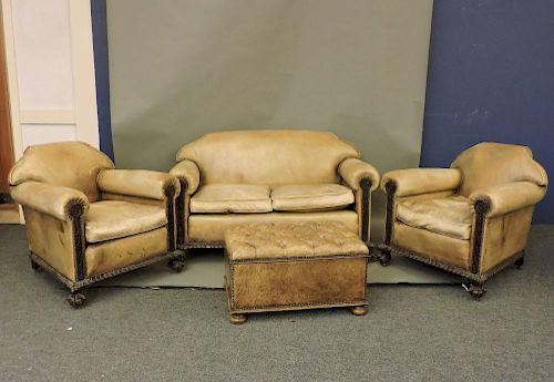 A late Victorian four piece suite, on heavily carved claw and ball feet, comprising settee, two armc