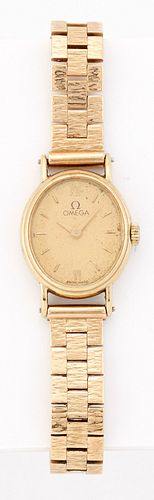 A LADY'S 9 CARAT GOLD OMEGA BRACELET WATCH,?oval champagne dial with gilt b