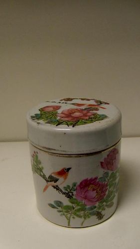 A late 19th/early 20th century Canton jar and cover painted with an iron red bird perched amongst pi