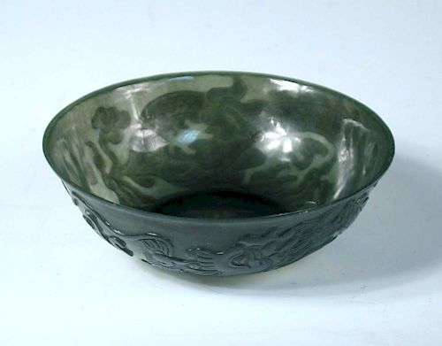A spinach green jade bowl bearing four character Qianlong mark, the translucently thin sides of the