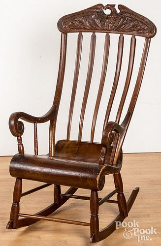 Rocking chair with carved eagle crest.
