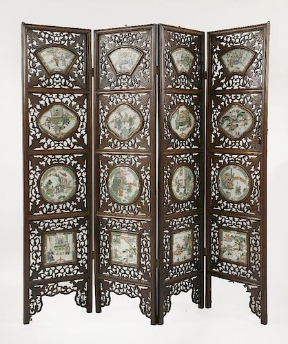 A hardwood four-fold Screen,<BR>late 19th century, each section inset with a shaped famille verte pa