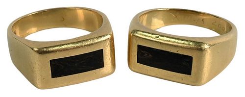 Two 18 Karat Gold Rings, both having center wooden insets, total weight 31.3 grams, sizes 11 1/2 inches and 12 1/2 inches.
