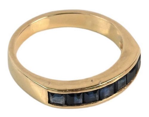 18 Karat Gold Ring, having seven blue sapphire baguettes, 3 grams.