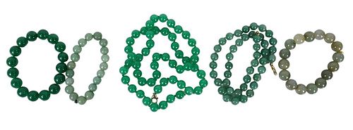 Five Piece Jade Lot, to include three jadeite bead bracelets, a bead necklace having 14 karat gold clasp; along with a jade bracelet having an unmarke