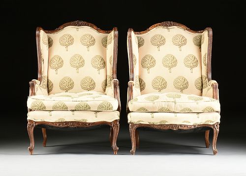 A PAIR OF LOUIS XV STYLE UPHOLSTERED AND CARVED WALNUT BERGÈRES A L'OREILLE, SECOND-HALF 20TH CENTURY,