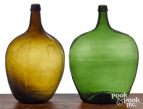 Two emerald and olive green glass demijohn bottles