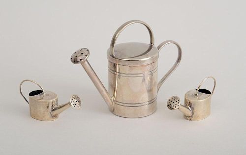 PAIR OF MEXICAN SILVER MINIATURE WATERING CANS AND A SCENTED CANDLE IN SILVER-PLATED WATERING CAN CONTAINER