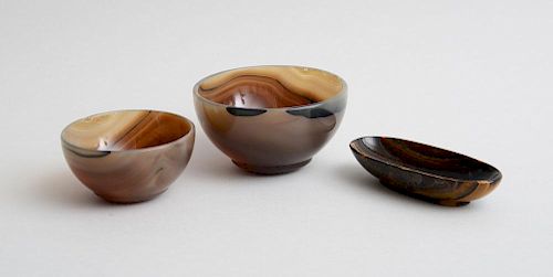 TWO CARVED AGATE BOWLS AND A CAT'S EYE OVAL DISH