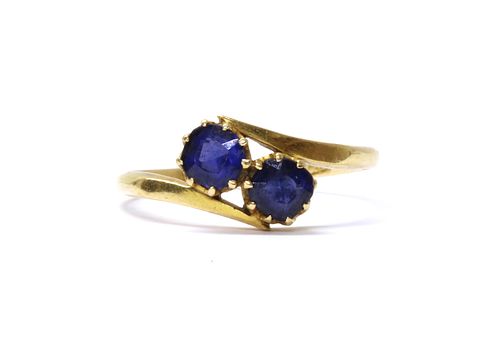 A gold two stone doublet crossover ring,