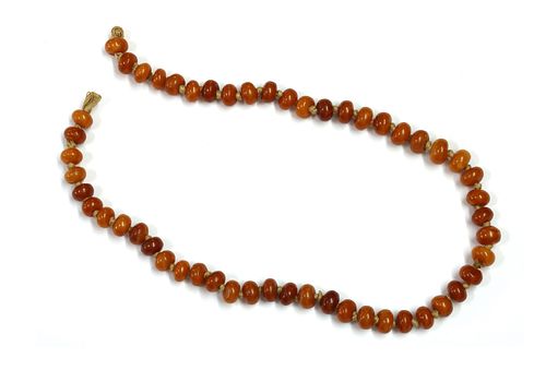 A single row uniform butterscotch amber bead string,