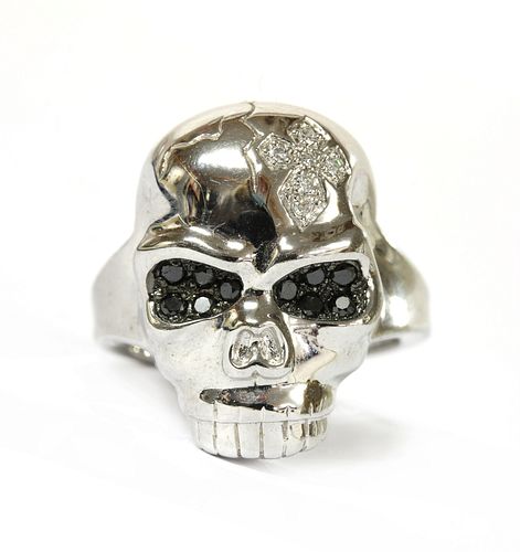 A 9ct white gold diamond set skull ring,