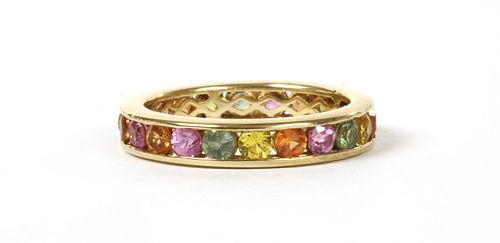 A gold varicoloured sapphire full eternity ring,