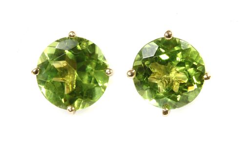 A pair of single stone peridot stud earrings,