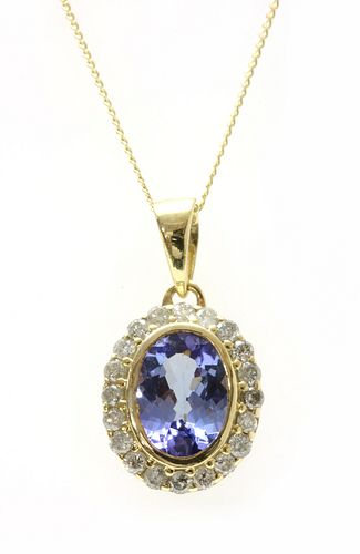 A gold tanzanite and diamond cluster pendant,