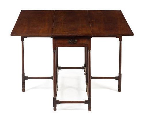 * An English Mahogany Gateleg Table Height 24 x width 36 1/4 x depth 40 inches.