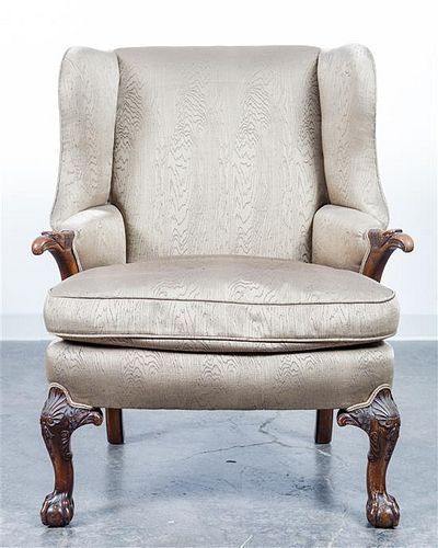 An Upholstered Wingback Armchair. Height 41 3/4 inches.