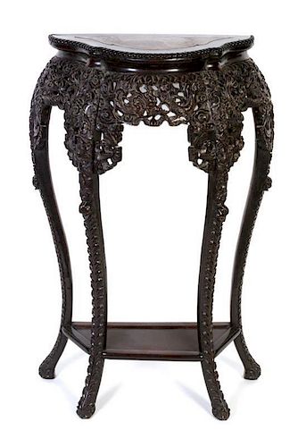 * A Chinese Carved Wood and Marble Side Table Height 36 x width 23 x depth 17 inches.