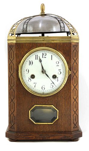 An oak and brass-mounted mantel clock,