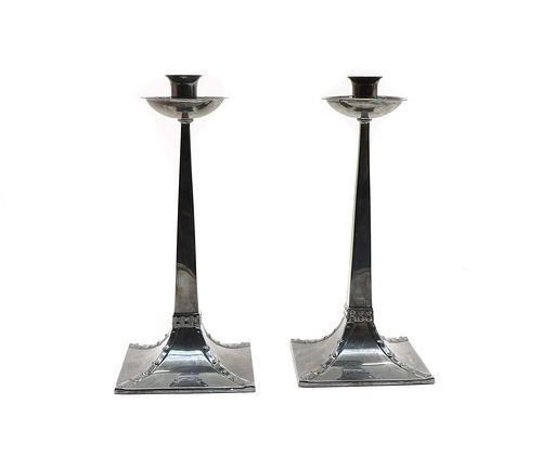 A pair of Arts and Crafts-style silver candlesticks,