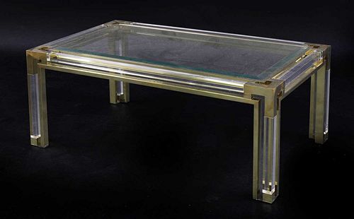 A Lucite and brass coffee table,