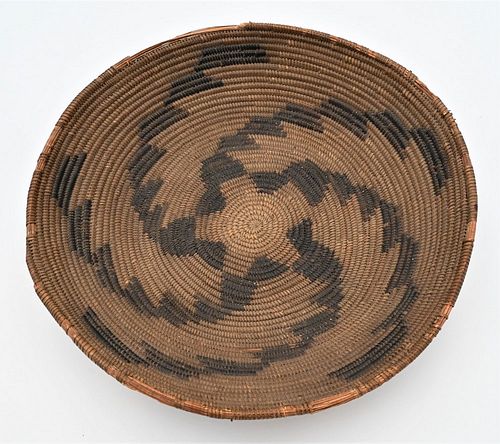 American Indian Coiled Basket
having black geometric designs 
(some rim damage)
height 3 inches, diameter 15 inches
Provenance: Estate of Bruce Sasall