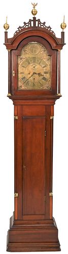 Walter H. Durfee Tall Case Grandfather Clockhaving shaped crest and brass finials, single door opening to brass dial, inlaid mahogany case with flute