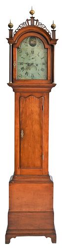 Asahel Cheney Tall Clock
having fretwork top over tombstone door, over shaped top door, on base with bracket feet, painted metal dial is marked Asahel