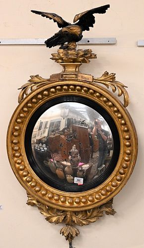 Gilt Convex Mirror
having black top eagle over mirror with foliate bottom ornament
height 39 inches, width 22 inches