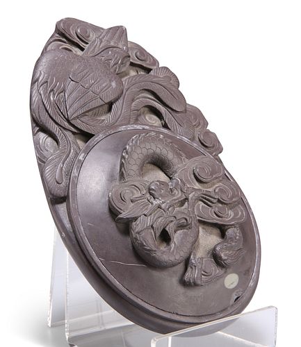 A CHINESE INKSTONE, 19TH CENTURY, the circular cover decorated in relief wi