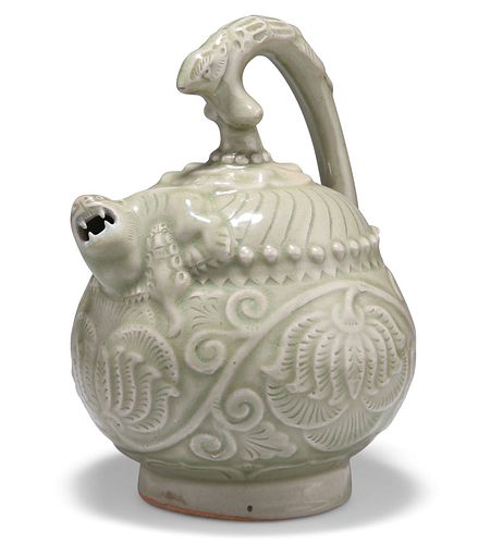 A CHINESE CELADON EWER, with zoomorphic handle and short spout, moulded wit
