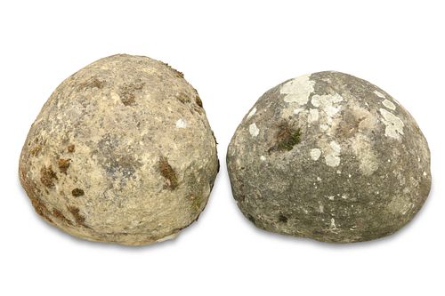 TWO WEATHERED STONE BALUSTER TREBUCHET PROJECTILES, later used as finials. 