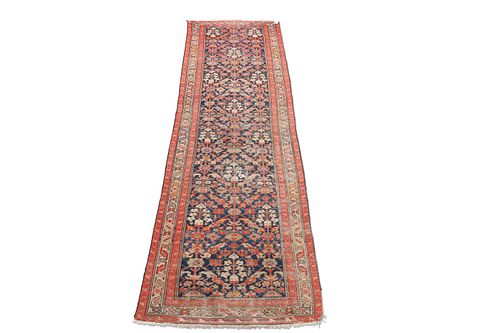 A MALAYER RUNNER, CIRCA 1930, the dark blue field with all-over orange and 