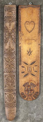 Two chip carved busks, 19th c., pre-dated 1753 and 1775, 13'' l. and 10 3/4'' l.