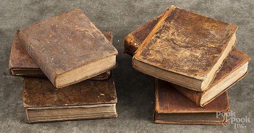 Six assorted leather bound books.