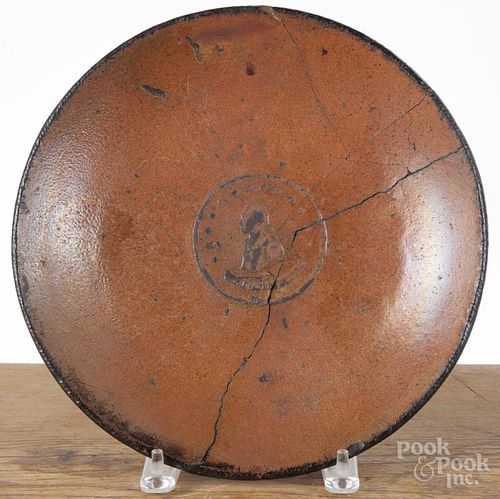 Redware charger, 19th c., with embossed medallion of George Washington, 11'' dia.
