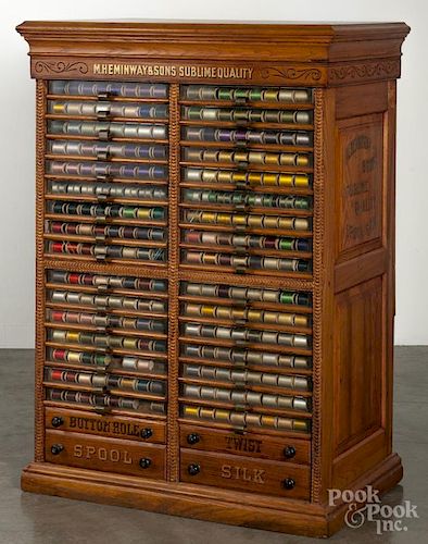 M. Hemingway & Sons floor standing oak spool cabinet fitted with a large assortment of early thread