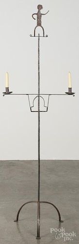 Wrought iron candlestand, 20th c., with an amusing figural finial, 65'' h.