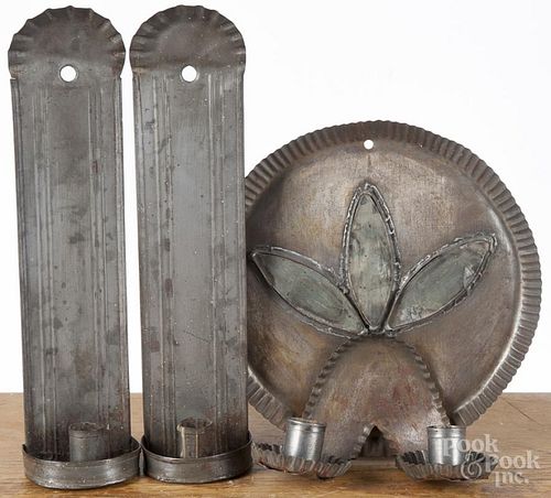 Tin wall sconce, 20th c., with a trefoil mirrored back, 9 3/4'' dia., together with a pair of sconces