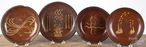Four Pennsylvania slip decorated redware pie plates/shallow bowls, 19th c., largest - 8 3/4'' dia.