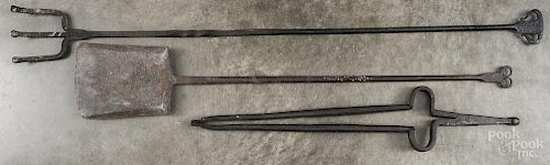 Three wrought iron fireplace utensils, 19th c., to include a shovel, tongs, and a fork