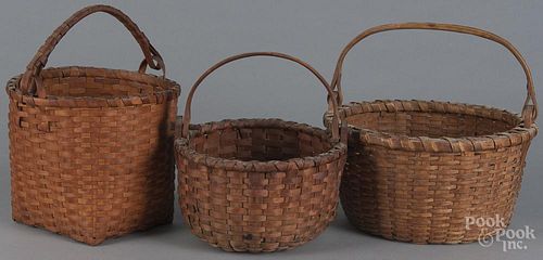 Three split oak baskets, 19th c., with swing handles, largest - 8'' h., 12 1/2'' w.