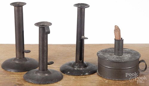Three hogscraper candlesticks, 19th c., together with a tinderbox with strike and flint
